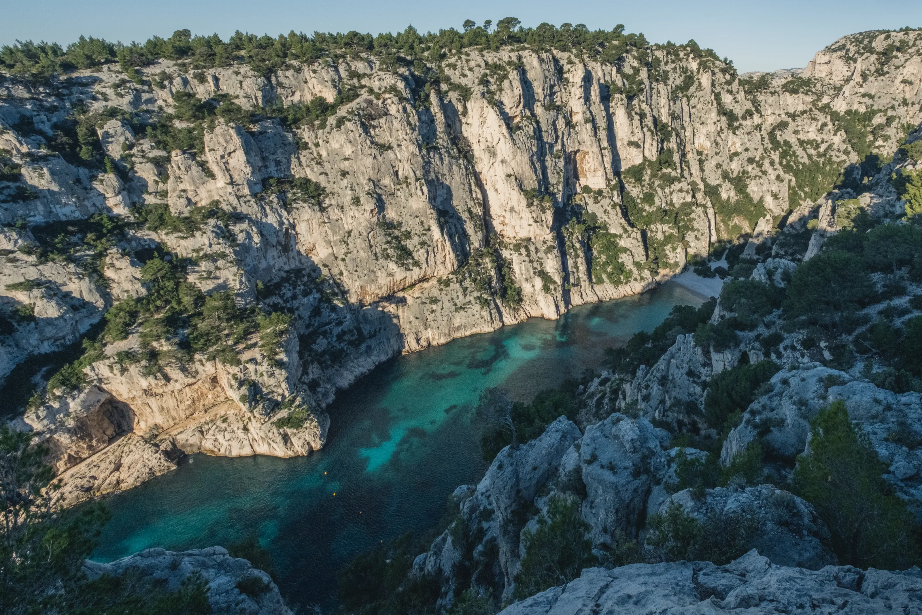 A turquoise bay deep between steep limestone walls
