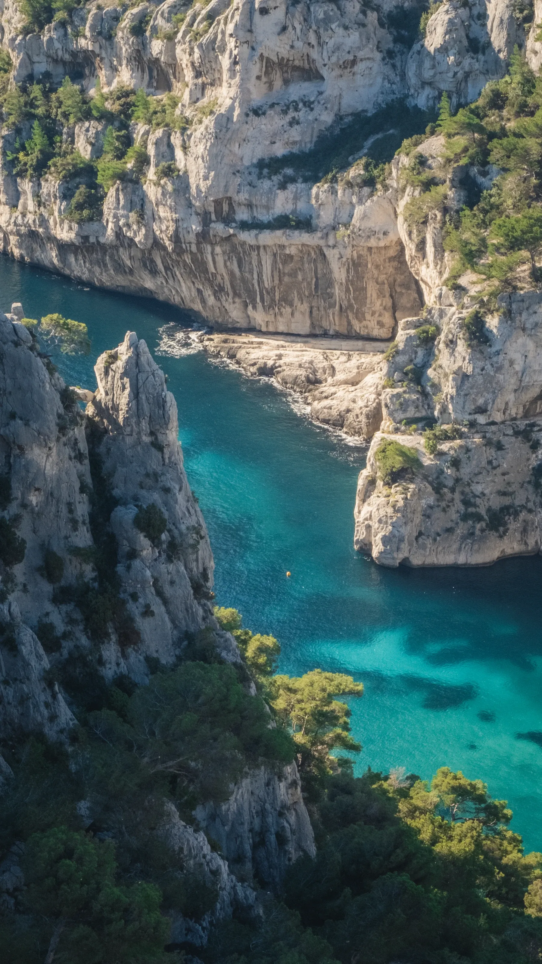 Limestone spires above a narrow turquoise cove